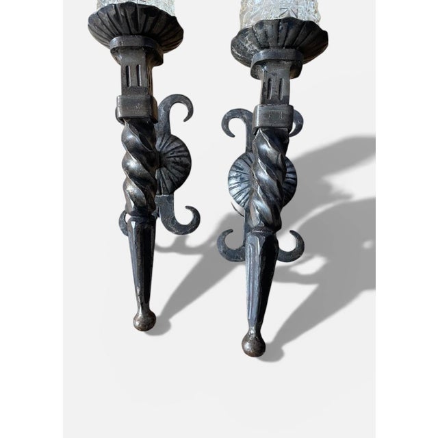 Pair of large early 20th-century wall sconces in the French Gothic style. Made of wrought iron with a beautiful patina,...