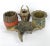 Circa 1930s cast iron pipe/tobacco holder in faux antler with cigar decorated cup on left and basket on right both lined...
