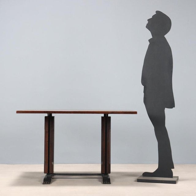 Table with enamelled metal base, exotic wood veneer. This piece is attributed to the mentioned designer/maker. It has no...