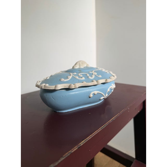 This listing is for a vintage, hand-painted lidded dish with Rococo-styling detailing in a cornflower blue color.