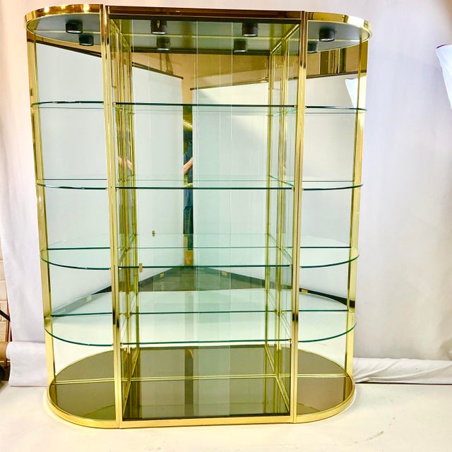 This is a stunning lacquered Brass, Glass, Mirrored, Lighted Display cabinet. It’s from the 1980s by Mastercraft.. The...