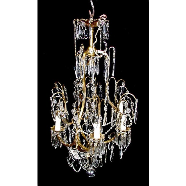 Cut crystal Italian style chandelier with six arms and a gilded gold brass frame. This light is restored. Included is a...