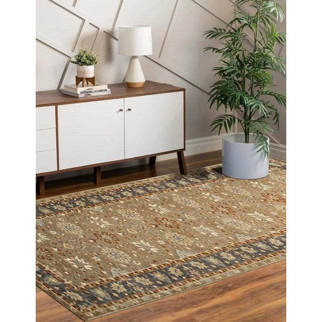 This gray wool rug features a hand knotted pile construction and originates from India. It represents a classic Oushak...