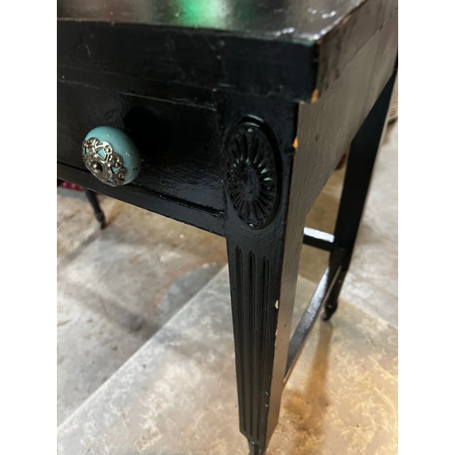 Up for consideration is a beautiful vintage simple black wooden desk on wheels with turquoise and silver knobs. This would...