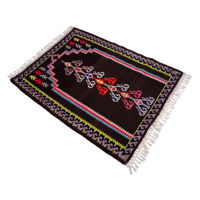 Woven in the high-altitude villages of Kars in Eastern Anatolia during the 1960s, this flatweave prayer rug is a...