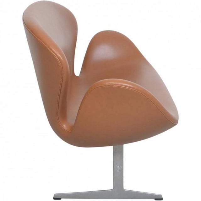 Arne Jacobsen Swan sofa upholstered in cognac classic semi anilin leather. The sofa is from 2001 but has been...