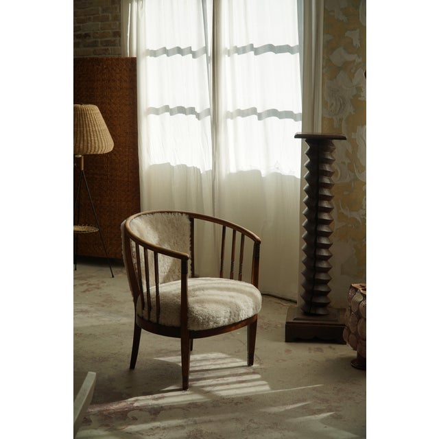 A rare pair of armchairs / lounge chairs in solid beech, reupholstered seat and back in a great quality shearling...