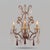 A pair of three-light wall sconces in the Louis XV style, made in the 20th century, probably in the first half. The...