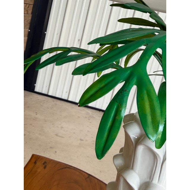 Striking and sculptural, this vintage table lamp pairs a glossy white ceramic column base with a beautifully detailed tole...