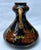 Here we have a vase decorated with raised tulips in oranges and green glaze , mustard interior and handles , 5.25" tall...