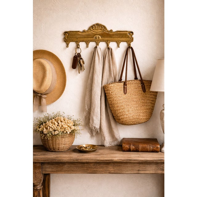 Elegant brass decorative wall plate with integrated 7 small hooks, crafted in Hungary and designed with refined classical...