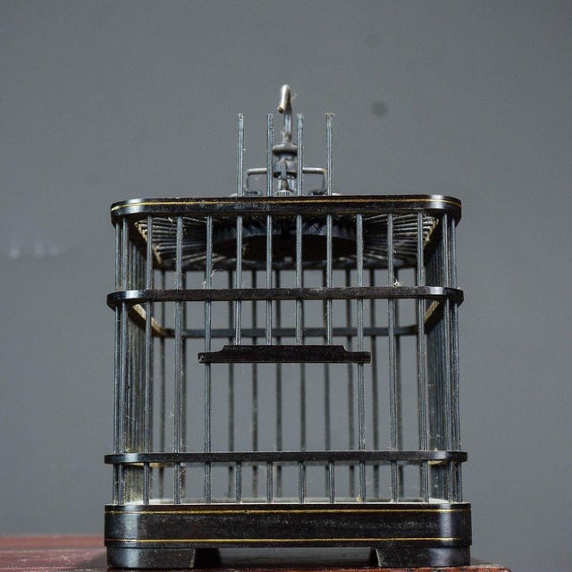 This distinctive vintage Chinese square cricket cage is handcrafted from dark black sandalwood with fine metal bars. The...