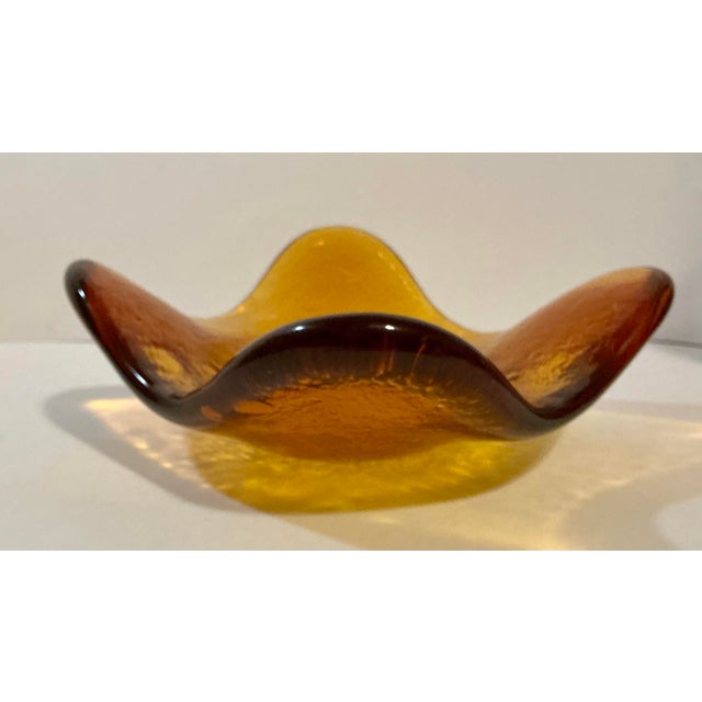 Striking vintage Blenko freeform art glass bowl attributed to designer Wayne Husted, dating to the mid century period....