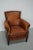 This cognac-colored leather club chair comes from the Netherlands. It is upholstered with cognac-colored leather and...