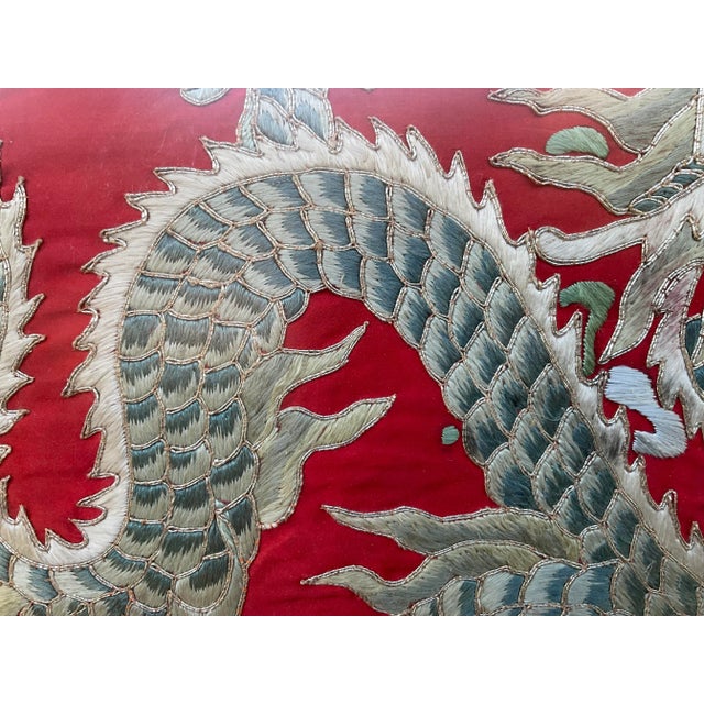 Vintage Chinese textile, with a finely detailed nicely dragon embroidery on red silk background. Displayed in a...