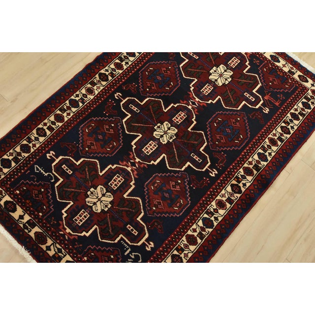 An authentic vintage tribal Hamedan rug hand-knotted with fine wool and natural dyes. This nomadic rug features geometric...