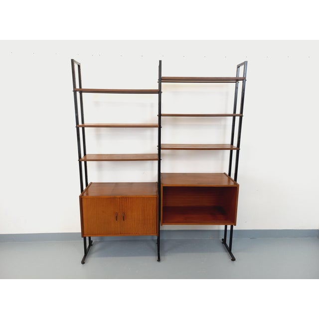 Vintage modular Scandinavian-style bookcase from the 1960s, in two parts, made of teak wood and black metal, with 6 open...