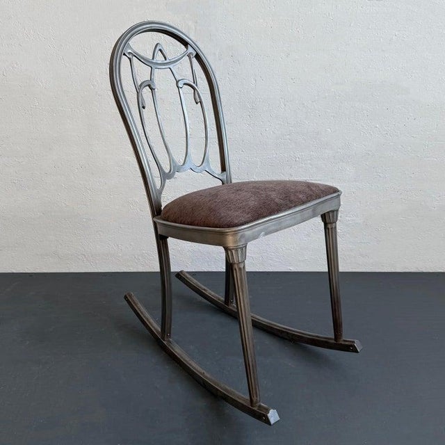 Vintage early 20th century, art deco rocking chair by The Doehler Metal Furniture Co. features a pressed, brushed steel...