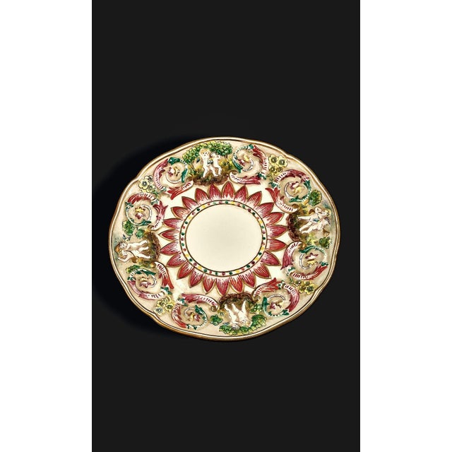 This wonderful Capodimonte porcelain tea cup and saucer set is a classic example of Italian Neoclassical and Baroque-...