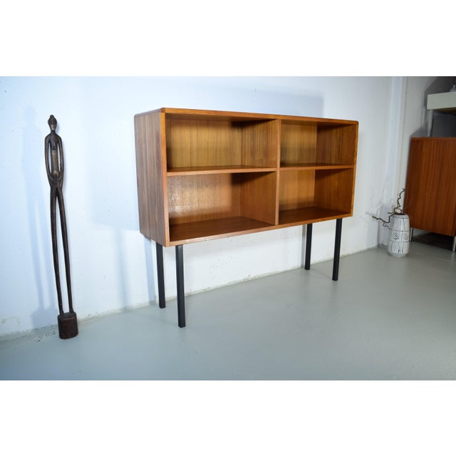 This is a Danish bookcase from the 1960s. The bookcase features a high-quality teak veneer with rounded corners. Both...