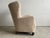 A Danish cabinetmaker wingback lounge chair produced in Denmark circa 1945–1955, newly upholstered in a sand-toned bouclé...