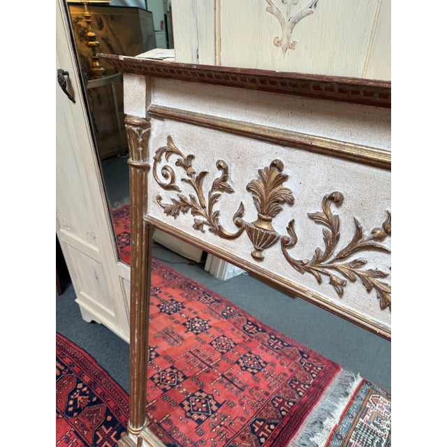 Design Plus Gallery presents a Gilt Trimmed Mantle Mirror with Neoclassical Design Elements. The gilt wood is whitewashed...