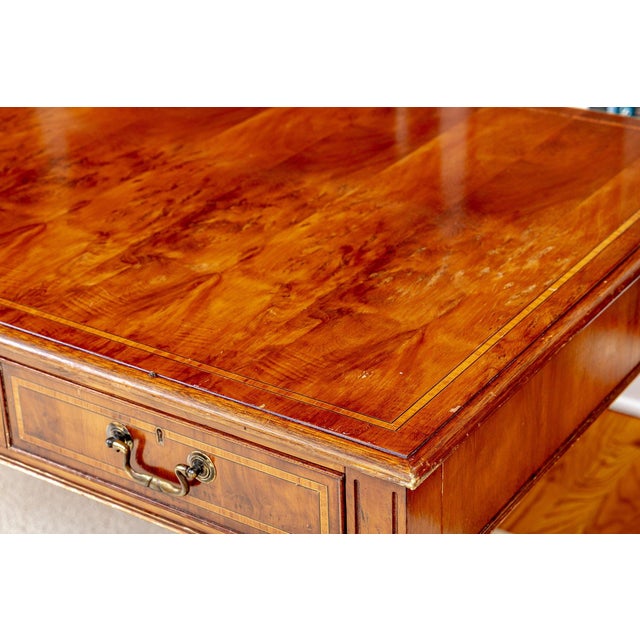 A Chippendale-style writing desk in mahogany with satinwood banding and brass hardware — a piece of scale, proportion, and...