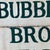 1930s Joyful Double Sided Wooden Trade Sign Advertising "Bubbling Brook Farm" in Green Paint For Sale - Image 10 of 10