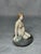 Classic Danish porcelain figurine depicting a mermaid seated on a rock, designed by Edvard Eriksen for Royal Copenhagen....