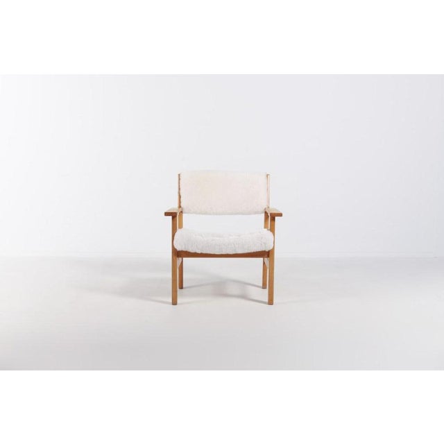 Vintage chair designed by Hans. J. Wegner for Getama. The seat and backrest is upholstered in sheep fur with a frame in...
