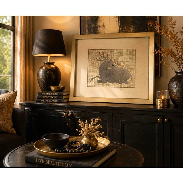 A beautifully textured and highly decorative framed artwork featuring a stylized reclining antelope rendered in an...