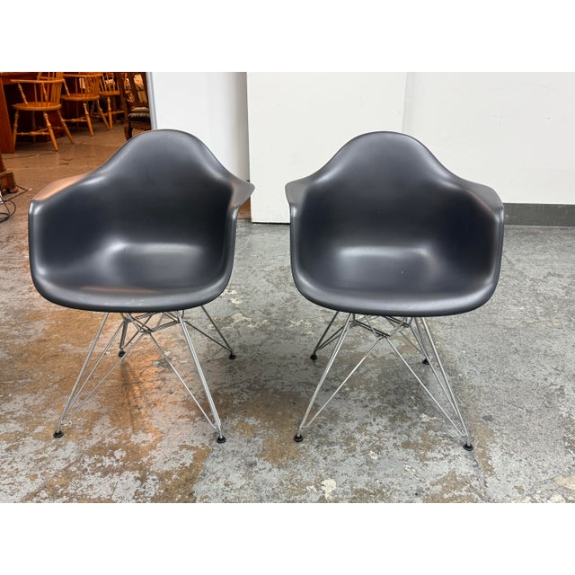 Design Plus Gallery presents a pair of Eames Plastic Armchair DAR chairs designed by Charles and Ray Eames for Vitra....