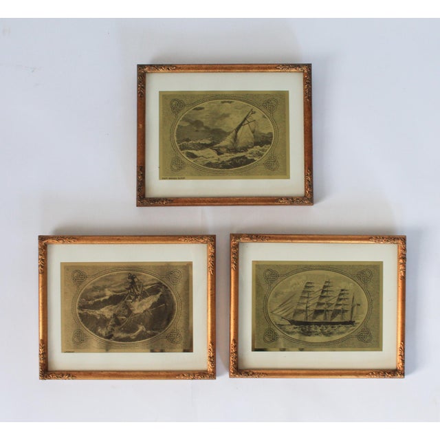Set of three vintage nautical-themed gold foil ship wall hangings in gilded wood frames. Ready to hang. Some age wear to...