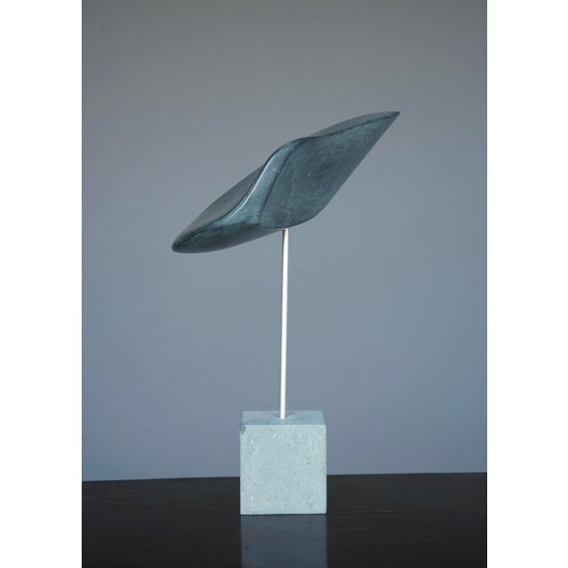 A stylish decorative sculpture. This polished stone sculpture has an organic form that works from all angles.