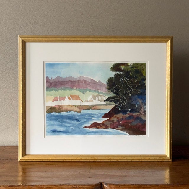 Watercolor painting depicting an old military barracks along a river. Signed by artist. Vintage gold frame. Newly framed...