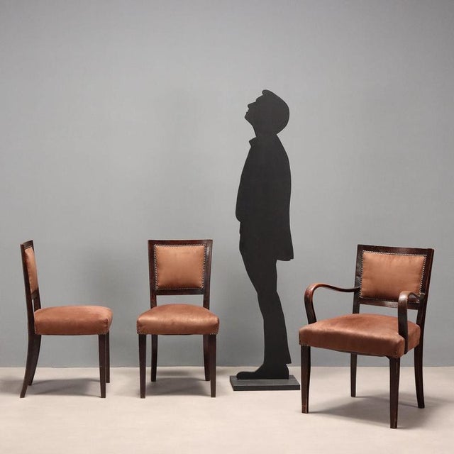 Set of three vintage chairs, including two chairs and a small armchair, with a stained wood frame, foam-padded seat and...