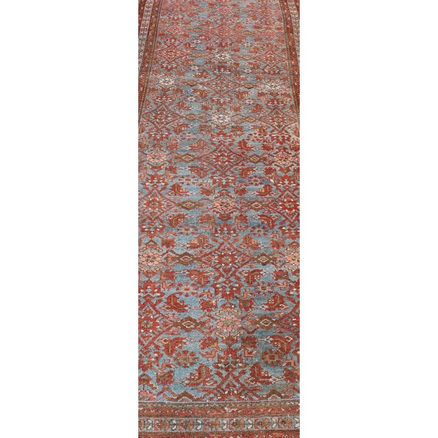 This magnificent antique Persian Malayer carpet, of an impressive size, bears a beautiful, all-over sub-geometric design...
