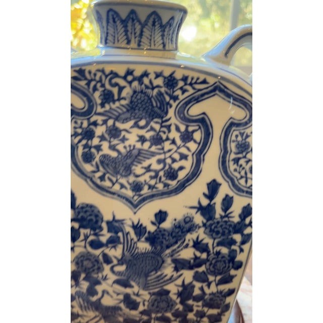Large 10.5" Chinese Blue & White Porcelain Moon Flask with Display Stand Add a touch of timeless Chinoiserie elegance to...