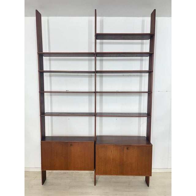 Beautiful, modular shelving system in timeless Scandinavian mid-century design. The unit impresses with its elegant teak...