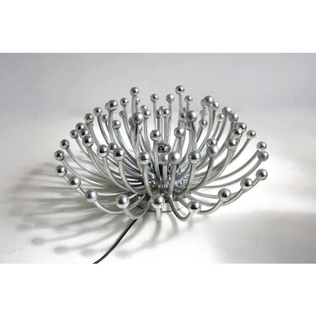 A striking vintage pistillo lamp designed by studio tetrarch for valenti luce in 1969. This versatile silver-colored lamp...