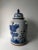 This blue and white porcelain jar is adorned with hand painted ever green and plum flowers. The lid has a small foo dog on...