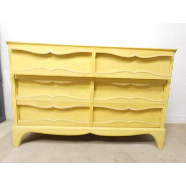 Charming yellow mid century lowboy dresser. It's swirl design on the handles are edged with a antiqued white paint look...