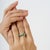 This hallmarked 925 sterling silver wave ring features 1.26 carats of natural emeralds in a combination of oval and round...