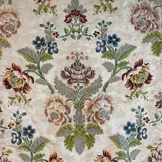 Round embroidered tablecloth from the 1700s, created by joining strips of patterned fabric, creating a seamless damask...