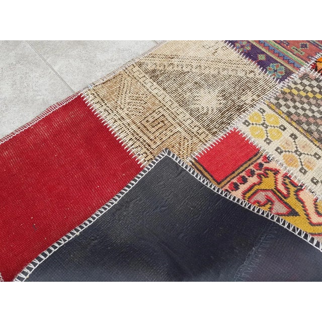 This is a vintage Turkish Oushak rug from the Mid 20th Century. The piece was hand-knotted.