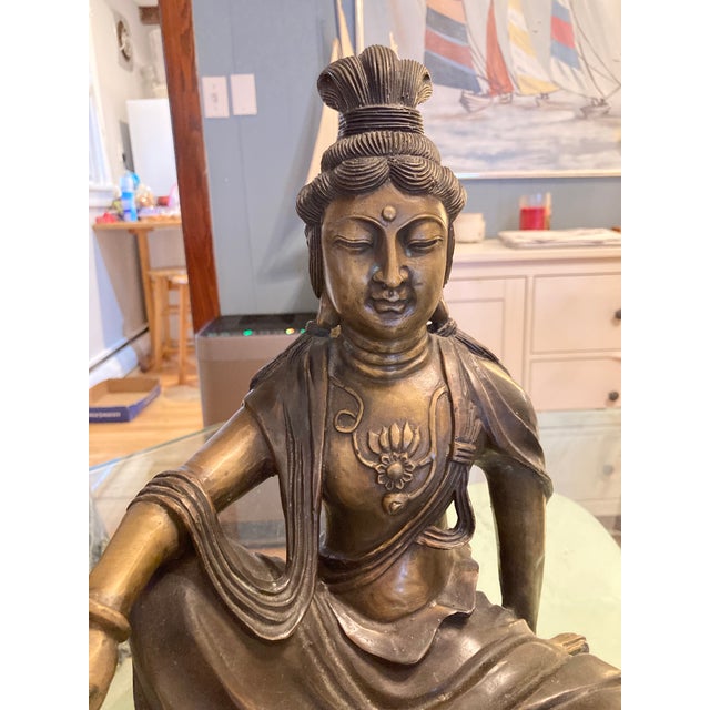 This is a statue of Guanyin, also known as Quan Yin or Kuan Yin, a bodhisattva associated with compassion and mercy in...