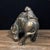 This is a vintage solid bronze sculpture depicting a cheerful boy interacting with a water buffalo. The piece features a...