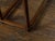 A pair of teak wood console tables from the 19th century with lateral drawer and humpback stretchers. This pair of 19th-...