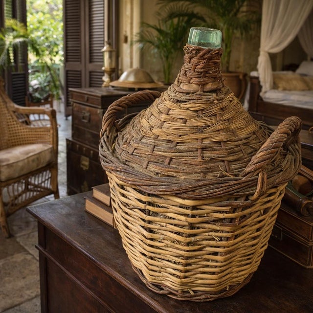 This large antique rattan/wicker demijohn is a true piece of history. Crafted using two tones of rattan/wicker and green...