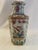 Beautiful Chinese vase with birds, butterflies, flowers and leaves. Pretty colors over a white vase include pink, gold,...